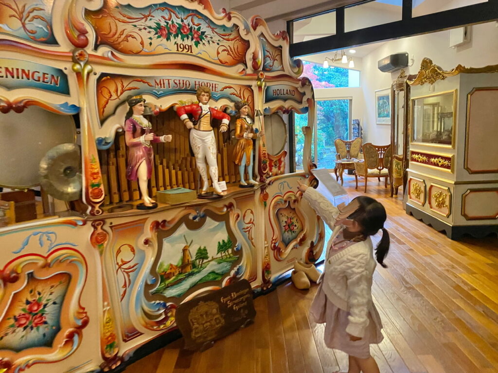 堀江オルゴール博物館入口に置いてあるオルガンとその前に立つ女の子